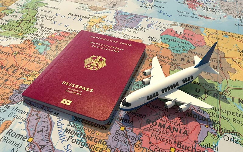 German passport with an airplane on a world map