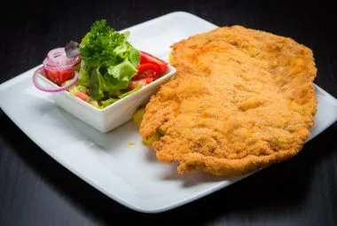 Crispy Schnitzel with Fresh Salad on Plate